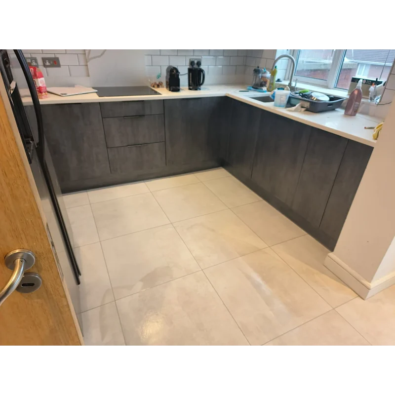 Kitchen with cream-white floor tiles and dark grey cabinets